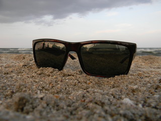 Fototapeta na wymiar Sun glasses laying down on a beach