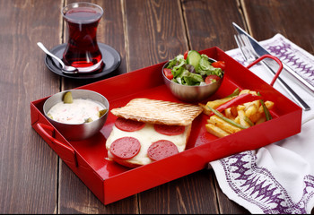 toast with potato salad and tea on a wood background