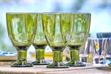 wine glasses on a wooden table in countryside