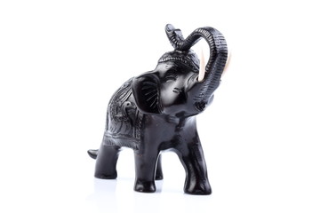 Black Engraved pattern gold elephant made of resin like wooden carving with white ivory. Stand on white background, Isolated, Art Model Thai Crafts, For decoration Like in the spa.