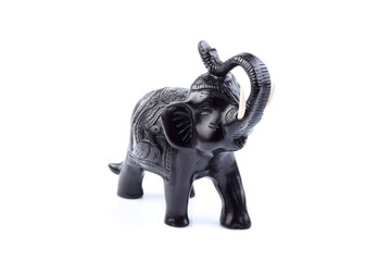Black Engraved pattern gold elephant made of resin like wooden carving with white ivory. Stand on white background, Isolated, Art Model Thai Crafts, For decoration Like in the spa.