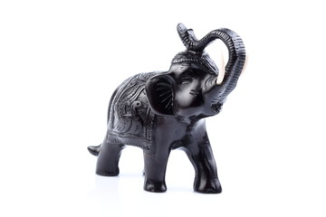 Black Engraved pattern gold elephant made of resin like wooden carving with white ivory. Stand on white background, Isolated, Art Model Thai Crafts, For decoration Like in the spa.