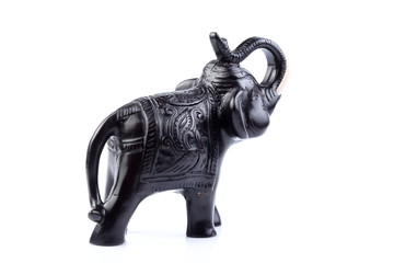 Black Engraved pattern gold elephant made of resin like wooden carving with white ivory. Stand on white background, Isolated, Art Model Thai Crafts, For decoration Like in the spa.
