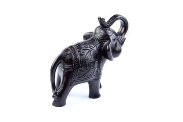 Black Engraved pattern gold elephant made of resin like wooden carving with white ivory. Stand on white background, Isolated, Art Model Thai Crafts, For decoration Like in the spa.