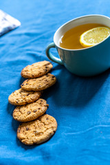 Tea with Lemon and Cookies with Chocolate Laying on Mattress
