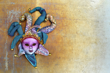 Venetian mask on grunge background with copy space. Flat lay carnival concept.