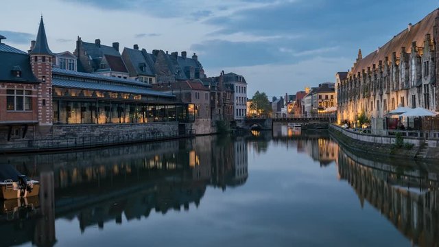 Pan motion timelapse video of the beautiful cityscape and Leie river from afternoon to sunset at Ghent, Belgium