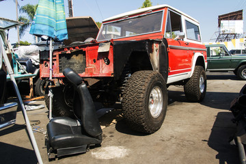 A view of a classic vintage 4x4 suv car in a repair shop 
