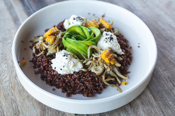 Delicious dish with Avocado, cheese, corn and sprouted wheat grains.