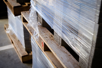 Obraz premium Siding pallet row set rack ready for construction on hardware industrial store inventory background. Manufacture production pattern stack, retail customer working shop abstraction storage backdrop.