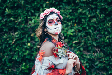 Obraz premium Closeup portrait of Calavera Catrina. Young woman with sugar skull makeup. Dia de los muertos. Day of The Dead. Halloween.