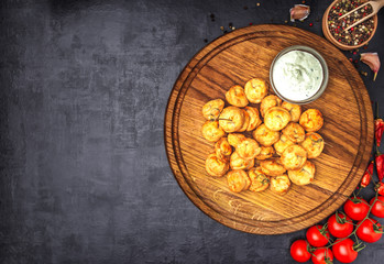 Dumplings stuffed with meat sprinkled with fresh herbs , top view, black background