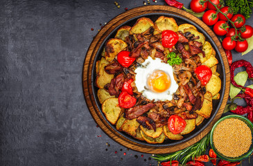 Baked potato wedges with cheese and herbs and tomato sauce on black background - homemade organic vegetable vegan vegetarian potato wedges snack food meal.