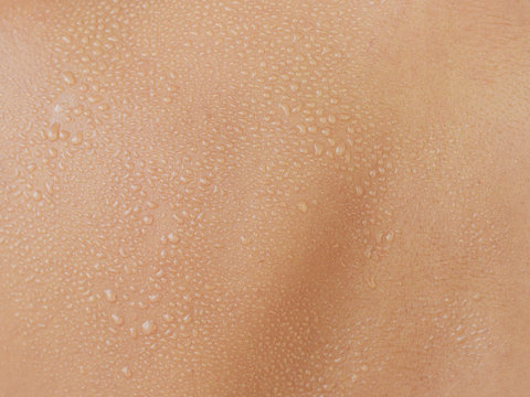 Water drops or sweat on human skin, texture or background

