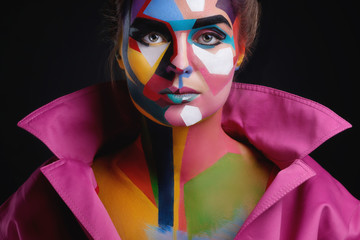 Model with a creative pop art make-up on her face