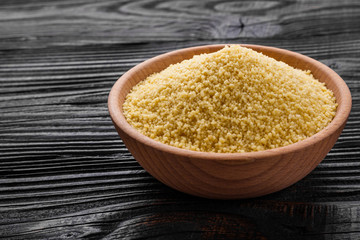 fresh couscous on a wooden rustic background
