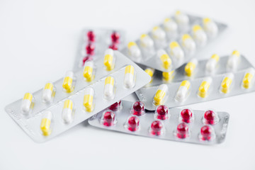 Closeup of several pill blisters isolated on white background, medicine and drugs concept