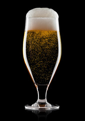 Cold glass of lager beer with foam and bubbles