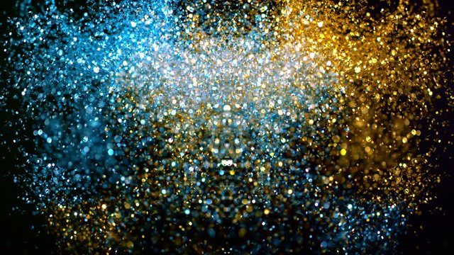 Golden and blue glitter explosion in super slow motion shooted with high speed cinema camera.