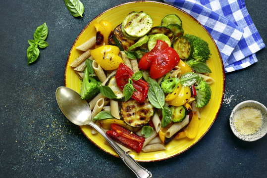 Whole grain penne pasta with grilled vegetables.Top view with copy space.