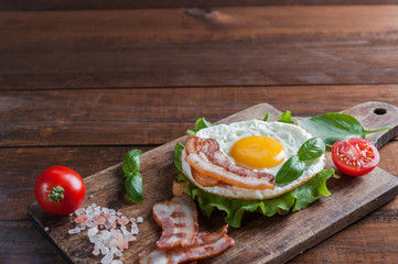 Fried egg and bacon on board