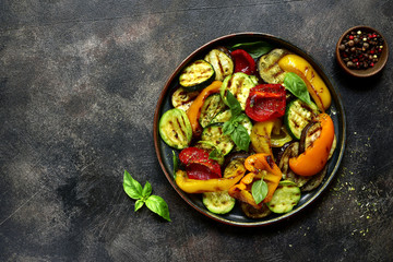 Grilled vegetables (  colorful bell pepper, zucchini, eggplant ) with basil and dry herbs.Top view.