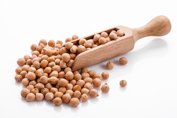 uncooked chickpeas on a white acrylic background