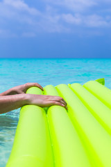 Swimming color green mattress on turquoise sea