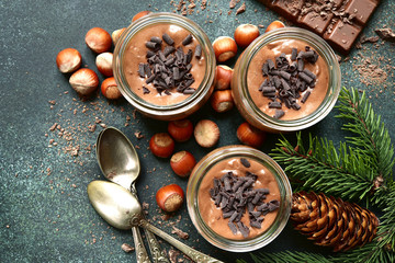 Homemade festive (christmas) chocolate mousse in a vintage glass jars.Top view.