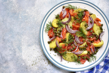 New potato salad with salted salmon, capers and red onion.Top view.
