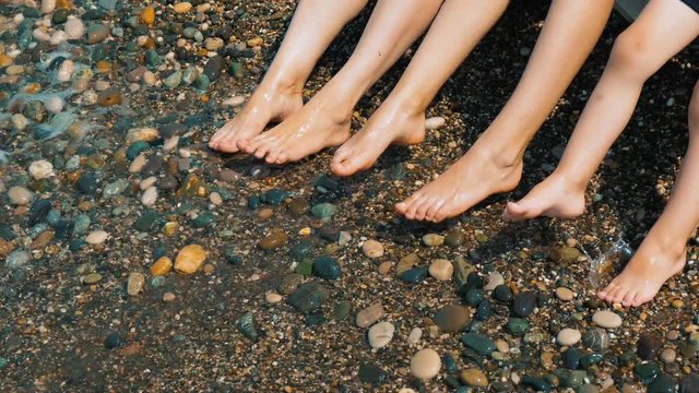 Summer Holiday. The Sea. Feet Splashing in the Surf