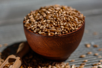 spelt seeds on a wooden rustic background