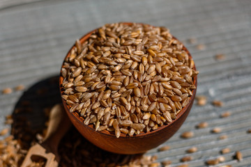 spelt seeds on a wooden rustic background