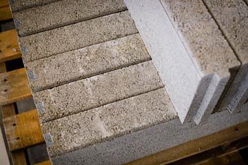 Pallet of concrete blocks industrial design building materials textured background. Build work storage unit.