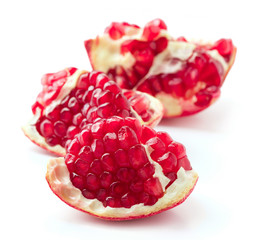 pieces of pomegranate fruit isolated on white background