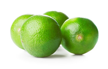 heap of fresh ripe limes isolated on white background