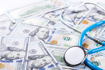 Stethoscope on dollar banknotes background