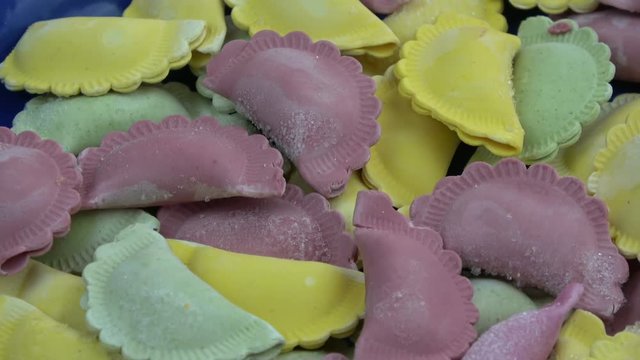 Rotating in blue ceramic plate frozen colorful dumpling