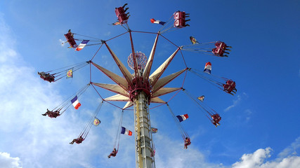 Flying chairs at the fair. Carousel. Paris. France