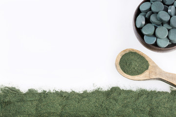 Spirulina algae powder and tablets. Spirulina