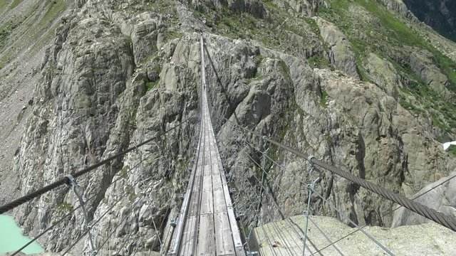 Walk through Trift Bridge, around lake, glacier and mountains, national park Switzerland, Europe. Summer landscape, sunshine weather and sunny day