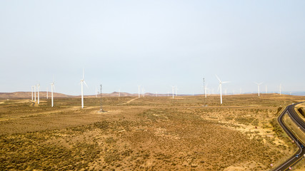 Drone photo of windmills in fields.