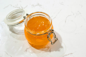 homemade pineapple jam in jar on white table