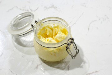 homemade butter in jar on white table