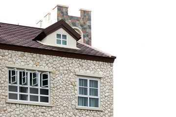 Fototapeta na wymiar windows and gable roof on stone house