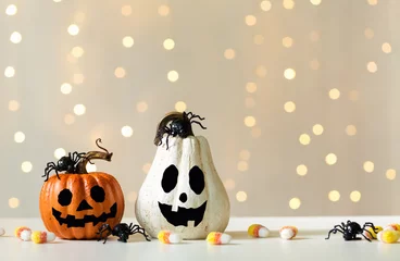 Foto auf Glas Halloween pumpkins with spider on a shiny light background © Tierney