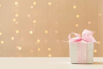 A gift box on a shiny light background
