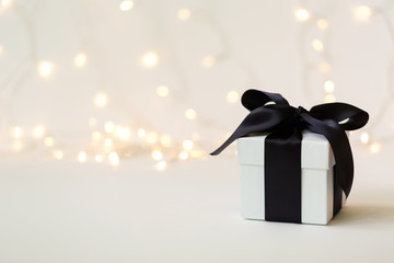 A gift box on a shiny light background