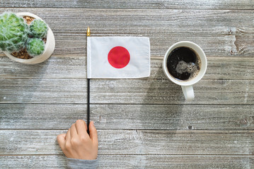 Japanese flag on a gray wooden desktop