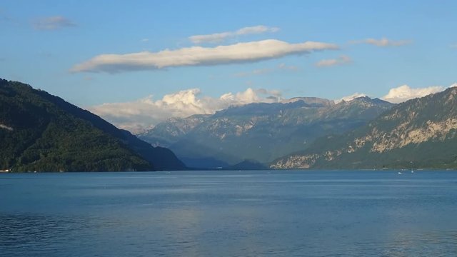 Time lapse view lake Thun (Thunersee) and mountains of Swiss Alps in city Spiez, Switzerland, Europe. Summer landscape, sunshine weather, blue sky and sunny day